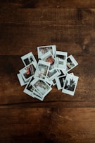 A stack of glossy and matte photographic prints with colorful borders.