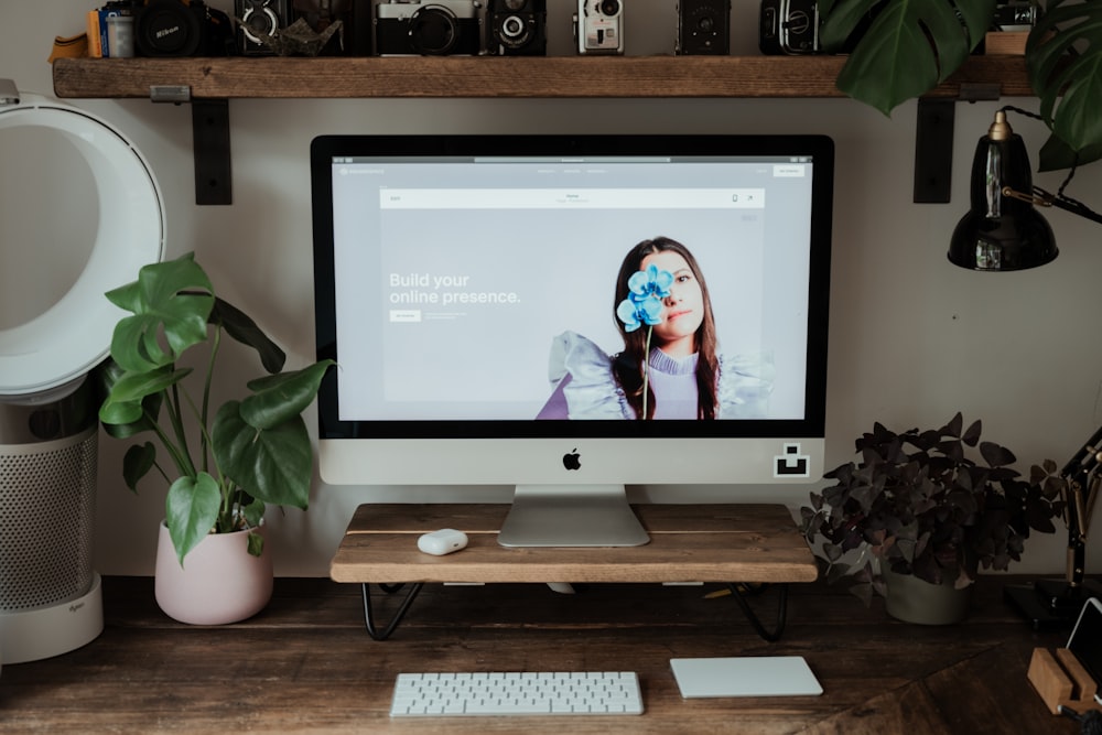 silver imac on brown wooden table