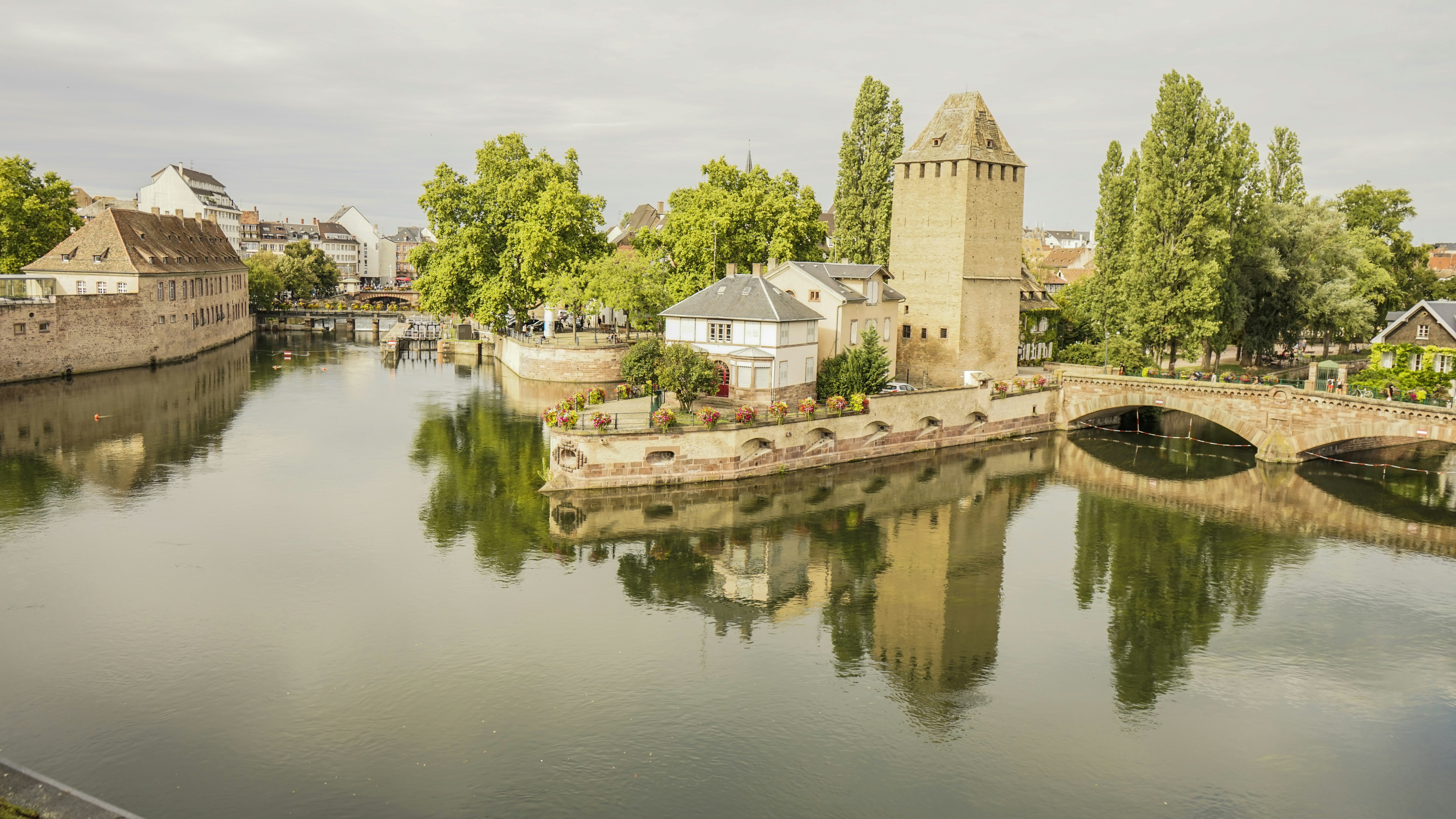 brown concrete building near body of water during daytime