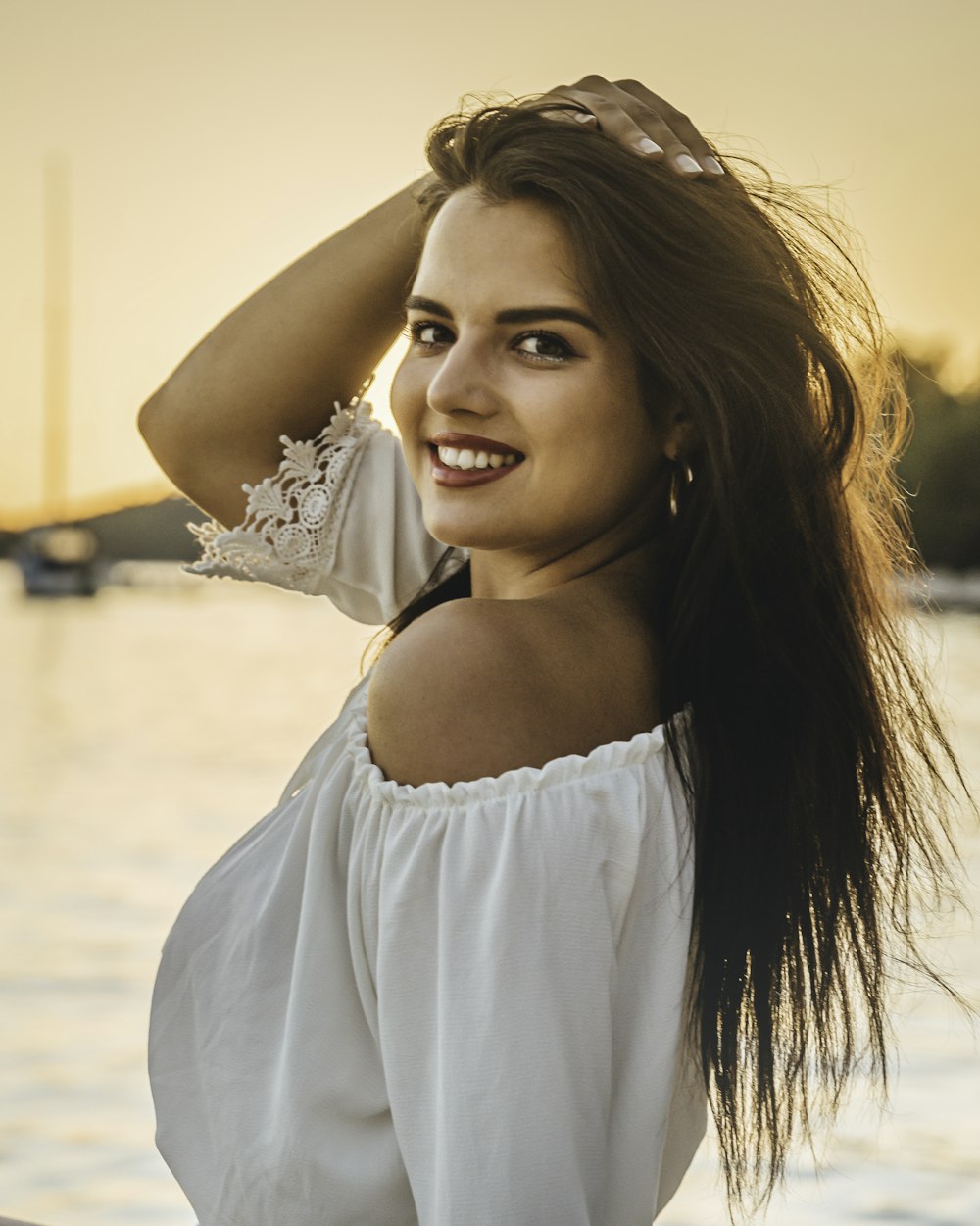 woman in white off shoulder shirt smiling