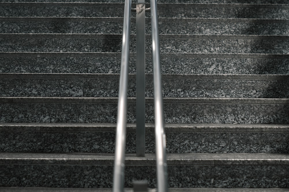 gray metal staircase with stainless steel railings