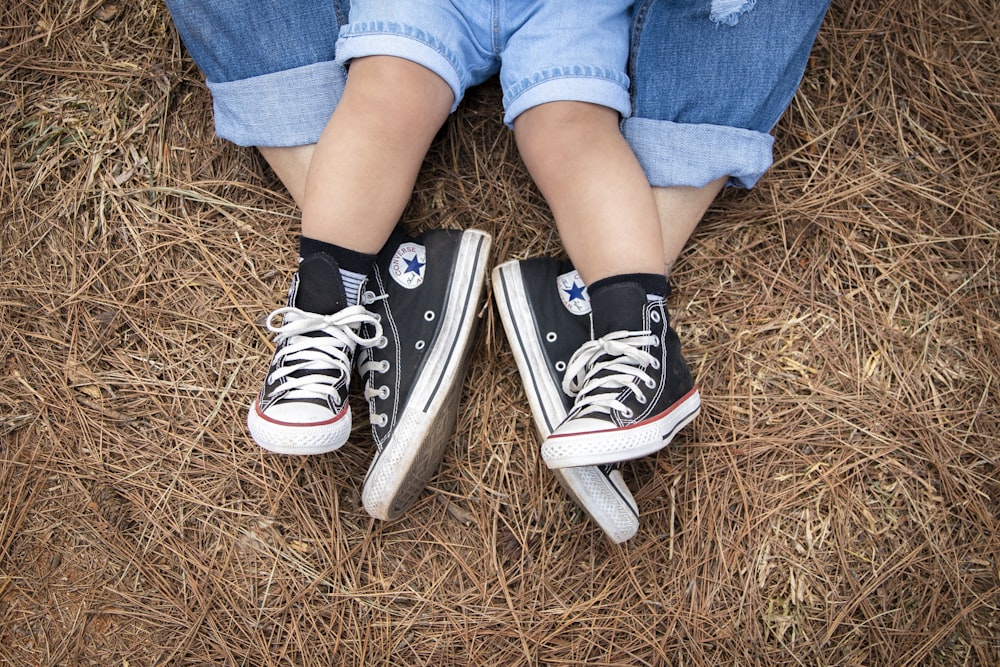 Person in blue denim jeans and black and white converse all star high top  sneakers photo – Free London Image on Unsplash
