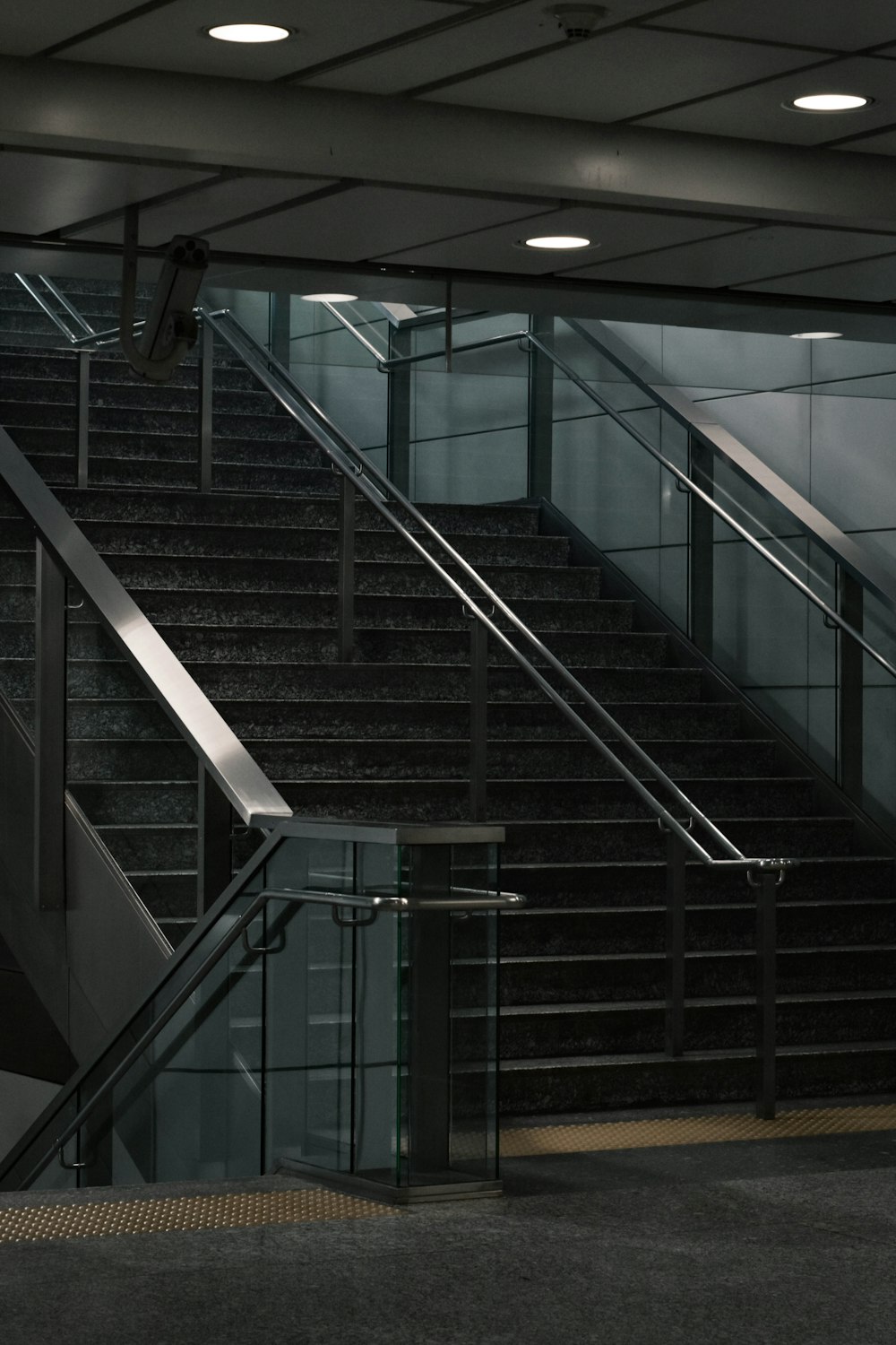 black and white staircase with stainless steel railings