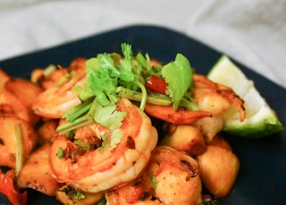 cooked shrimps on blue ceramic plate