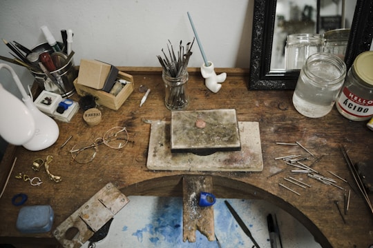 Close-up of various raw materials and tools laid out on a workbench, ready for crafting.
