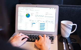 person using macbook pro on black table