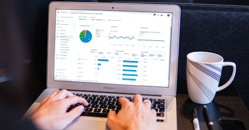 person using macbook pro on black table