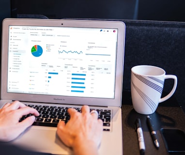 person using macbook pro on black table