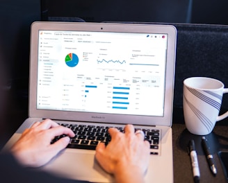 person using macbook pro on black table