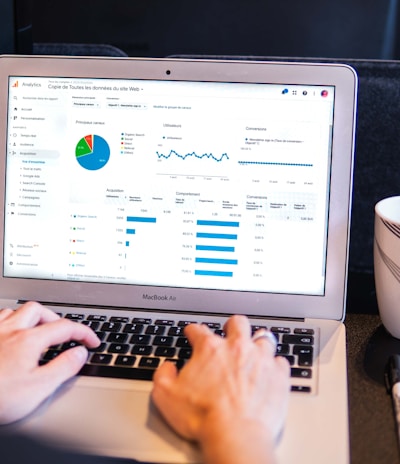 person using macbook pro on black table