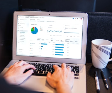 person using macbook pro on black table