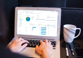 person using macbook pro on black table