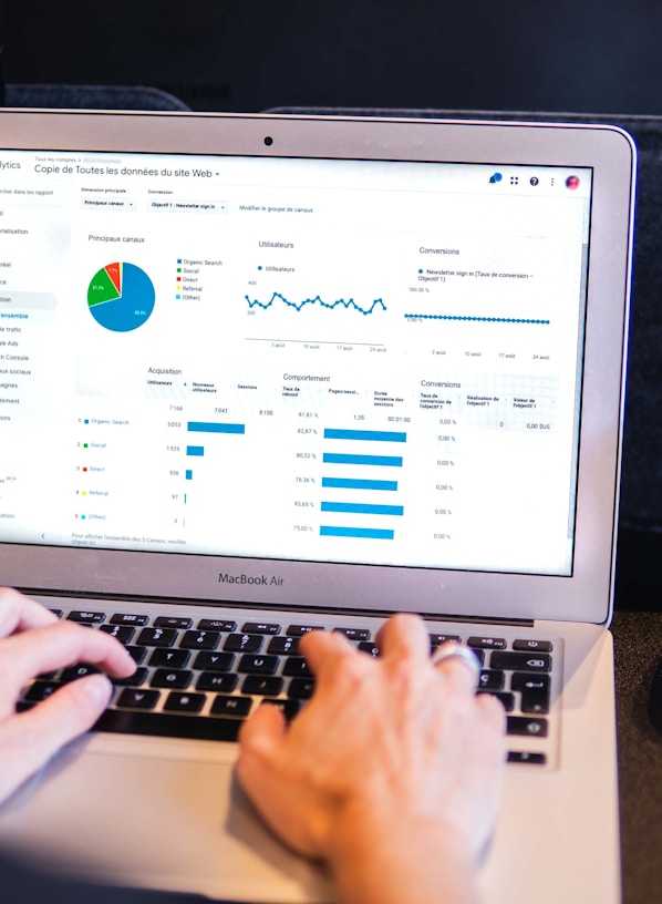 person using macbook pro on black table