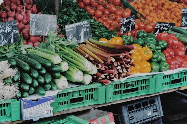Fresh vegetables including radishes, tomatoes and peppers displayed in crates