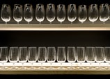 clear drinking glasses on blue wooden shelf