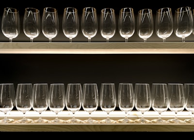 clear drinking glasses on blue wooden shelf