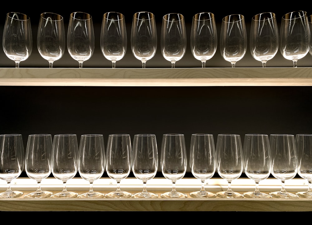 clear drinking glasses on blue wooden shelf