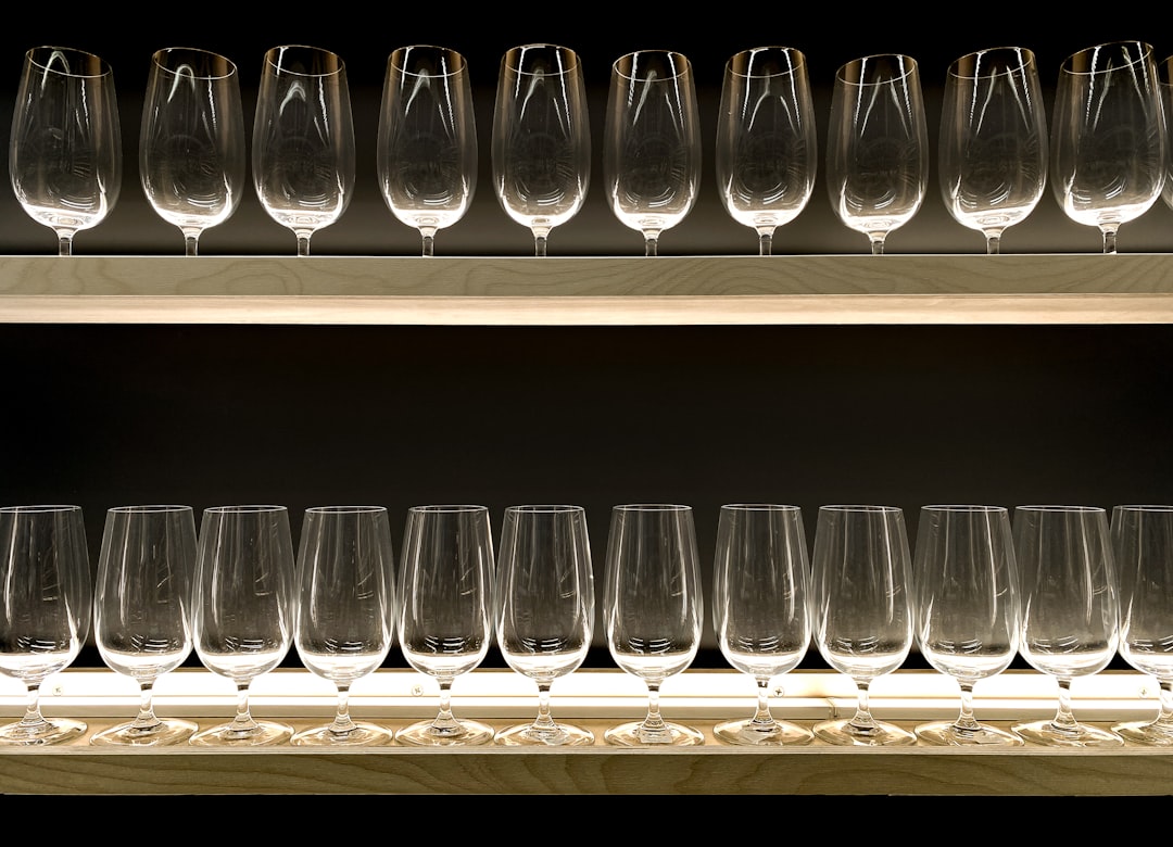 clear drinking glasses on blue wooden shelf