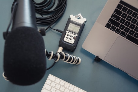 A neat workspace showing headphones, a microphone, and legal notes ready for transcription.