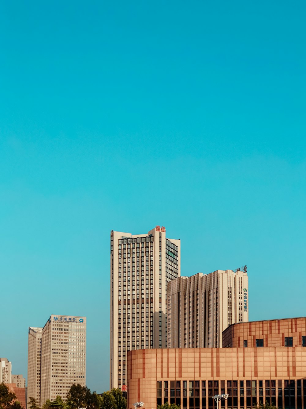 brown and white high rise buildings under blue sky during daytime