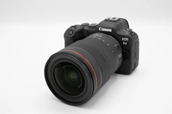 Close-up of a sleek camera branded with a popular photography influencer's logo.
