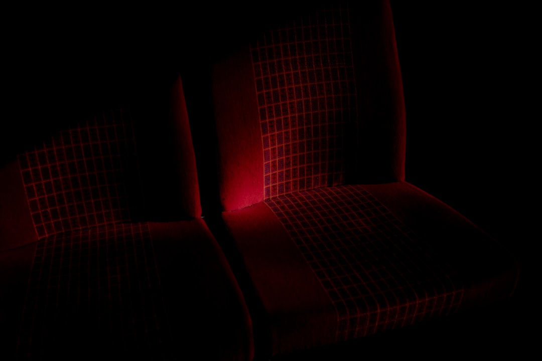 red sofa chair in dark room