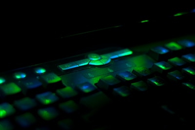 Close-up of a keyboard controller with illuminated keys in a creative workspace.