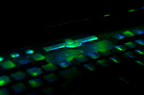 A close-up shot of a high-tech gaming keyboard with electric cyber green backlight illuminating each key.