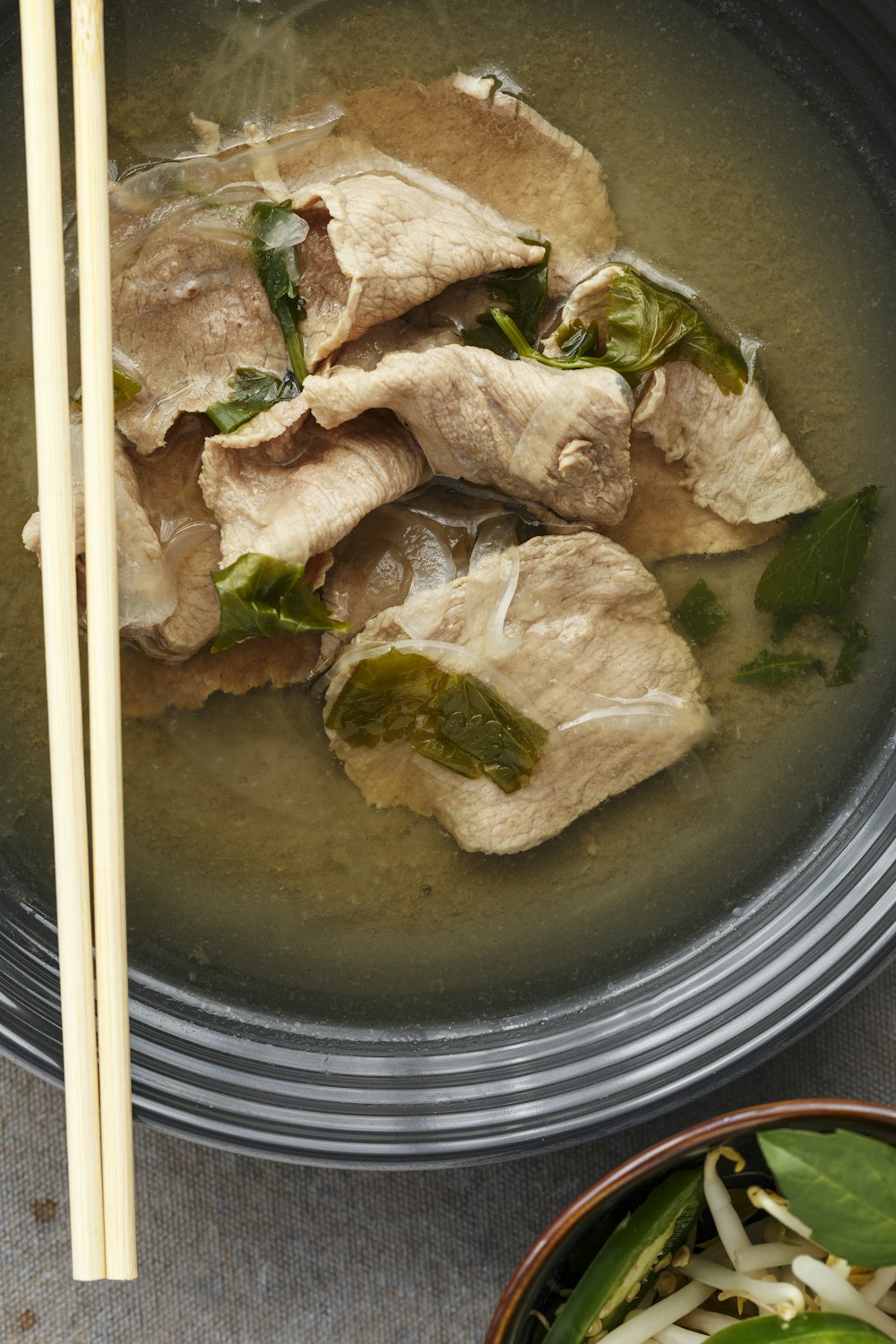 white chopsticks on black ceramic bowl