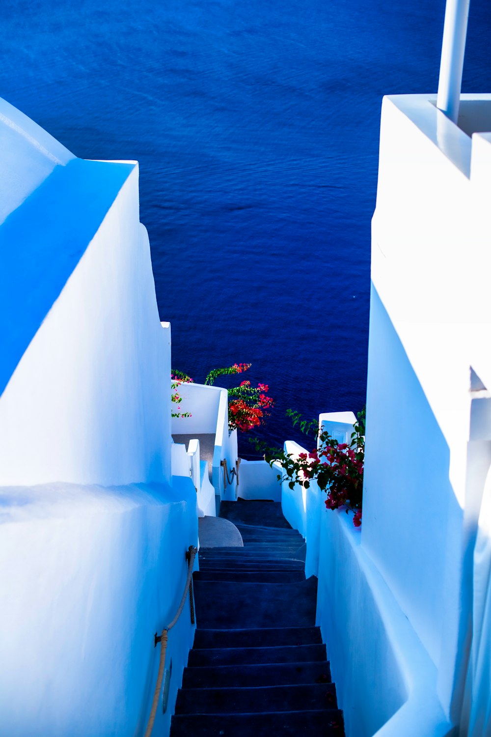 white concrete staircase near body of water during daytime