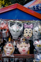 Colorful carnival masks hanging on a festive street stall during Sabadell's carnival.