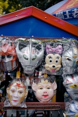 A vendor showcasing superhero masks and costumes at a lively fan event.