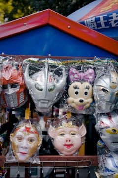 A vendor showcasing superhero masks and costumes at a lively fan event.