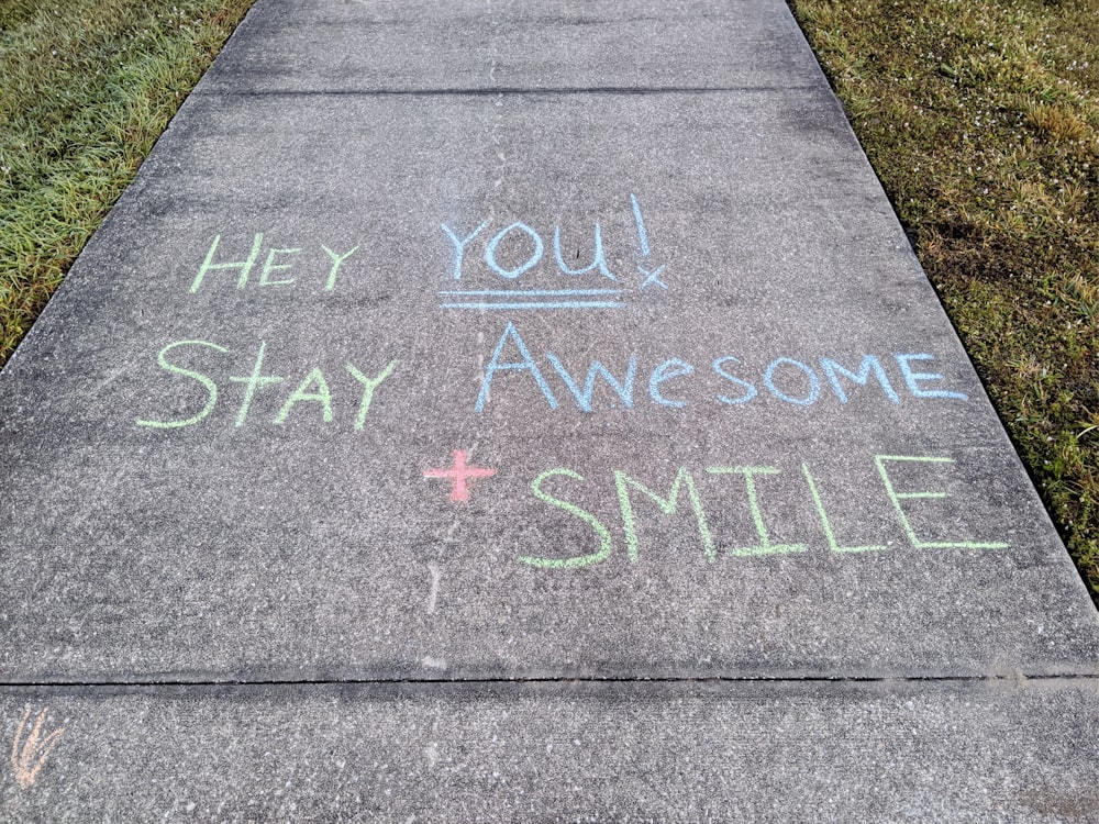 a sidewalk with a message written on it