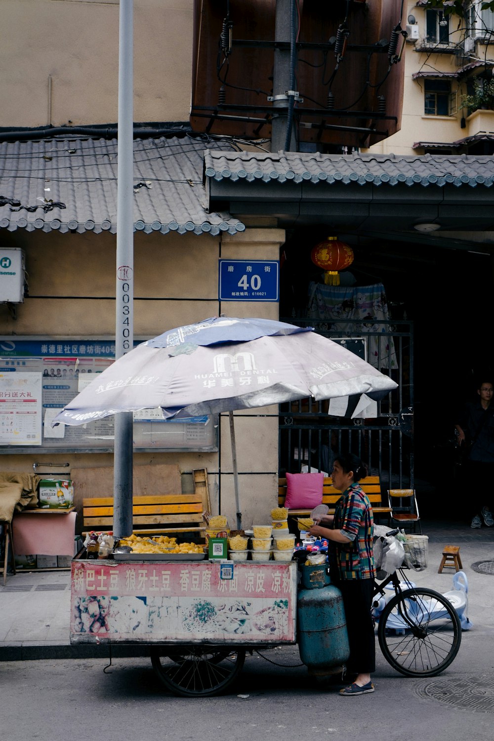 white umbrella on yellow and blue bicycle