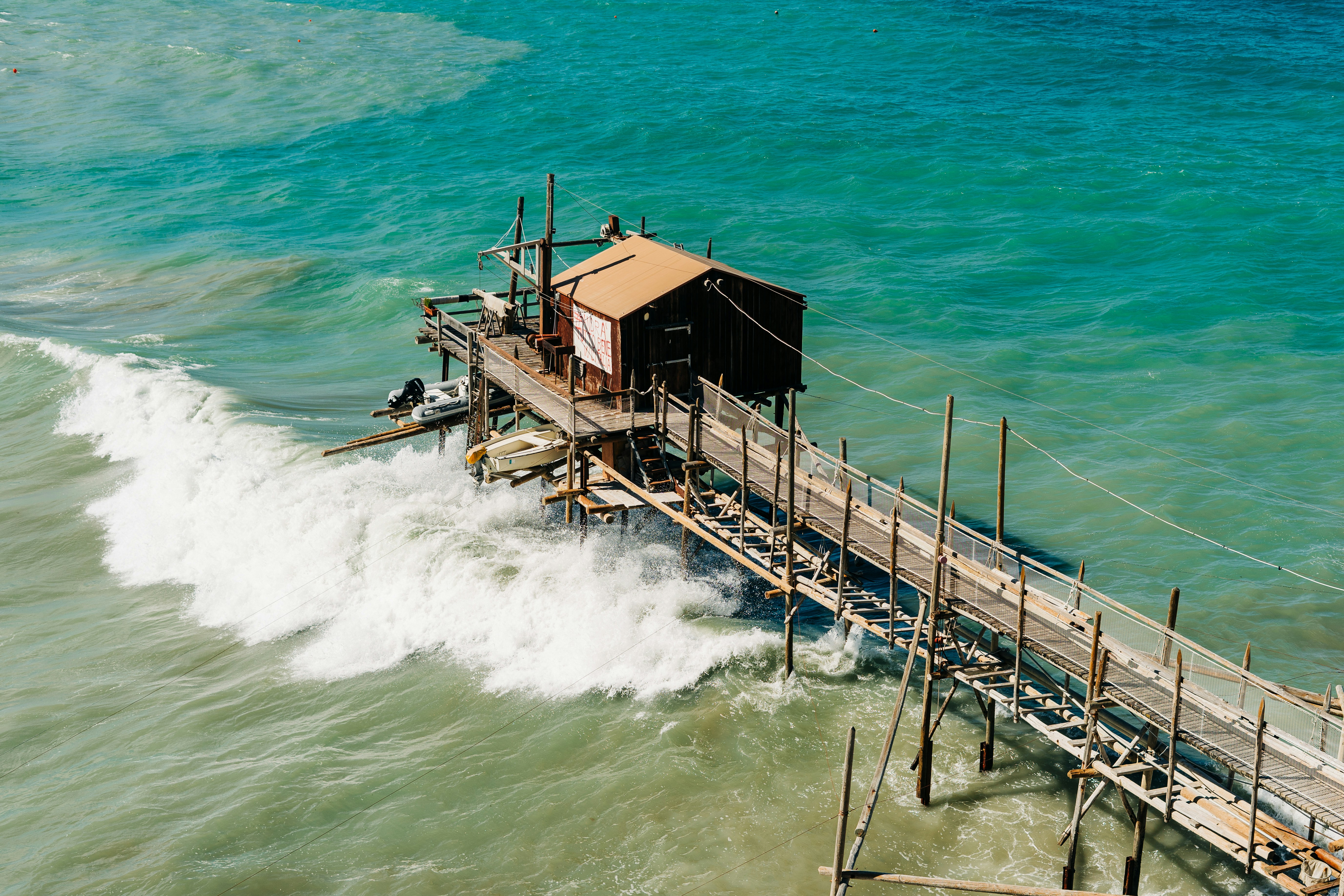 brown wooden dock on sea during daytime, A characteristic fishing platform or trabucco in the Adriatic sea 