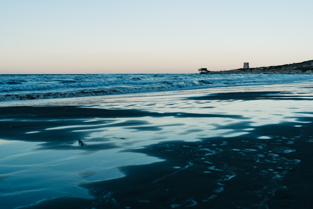 body of water under blue sky during daytime