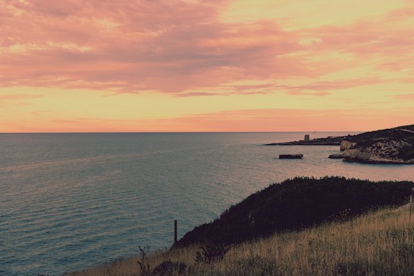 Body of water under cloudy sky during sunset — Puglia, Italy