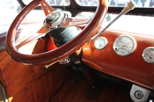 Close-up of a classic GMT400 Chevy dashboard with vintage gauges and wood trim.