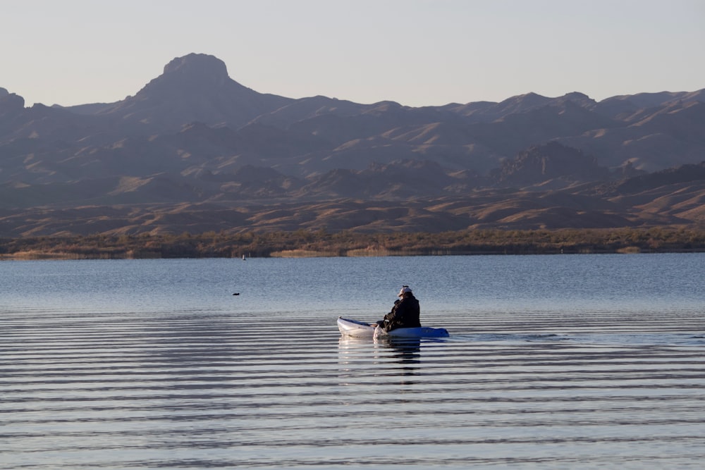 man riding on boat on sea during daytime