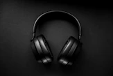 black wireless headphones on black surface