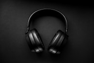 black wireless headphones on black surface