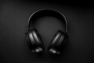black wireless headphones on black surface