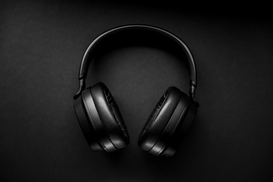 black wireless headphones on black surface