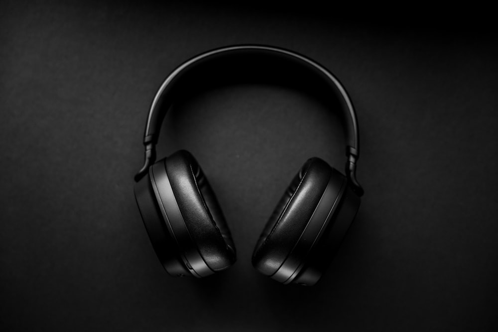 black wireless headphones on black surface