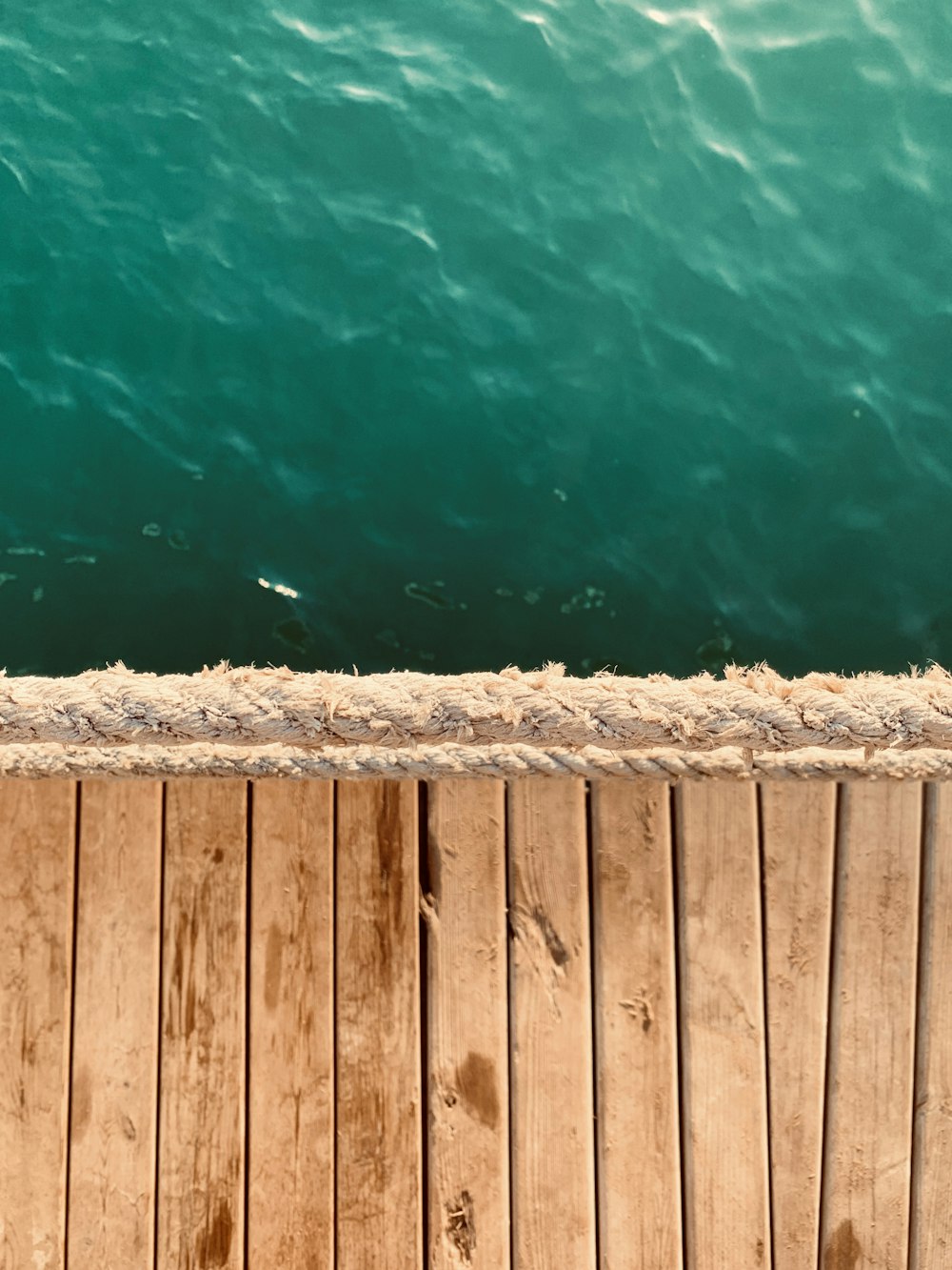 brown wooden dock over blue water