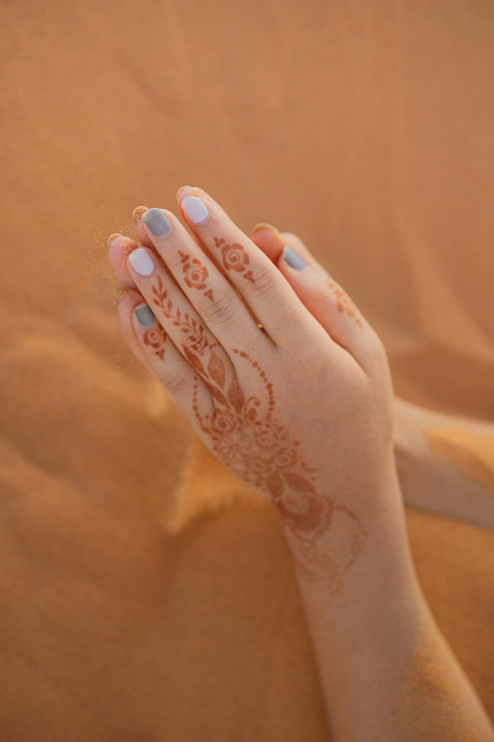 person with white floral tattoo on left hand