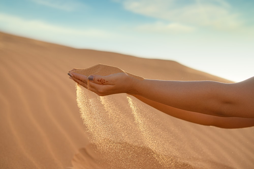 person in brown sand during daytime