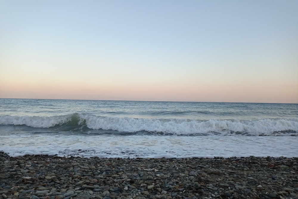 ocean waves crashing on shore during daytime