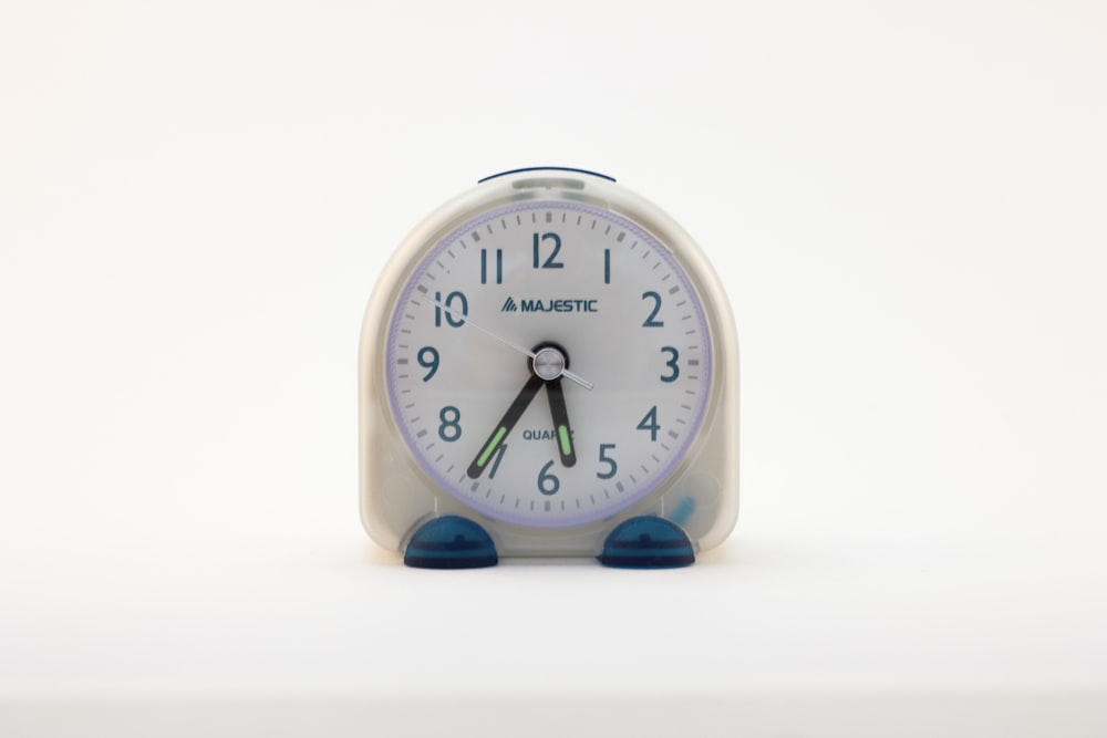 white round analog wall clock at 10 00